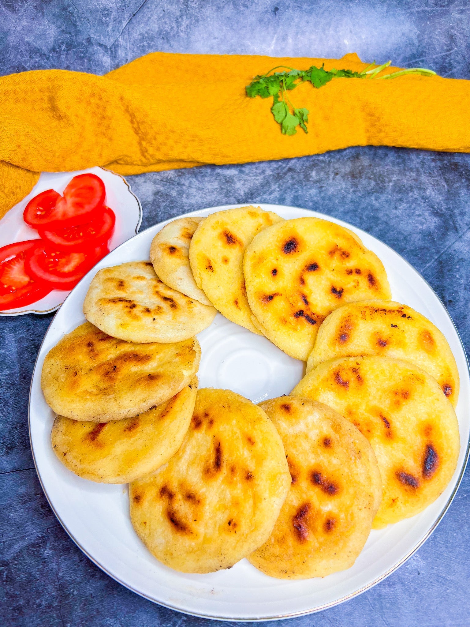 Goldbraun gebratene Arepas, gefüllt mit geschmolzenem Käse, serviert als südamerikanisches Streetfood.